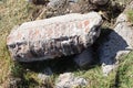 A piece of a fallen wall on the grass lies Royalty Free Stock Photo