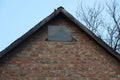 Part of an old brown brick attic of a rural house Royalty Free Stock Photo