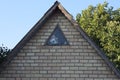 Part of an old brown brick attic of a rural house with a small window Royalty Free Stock Photo