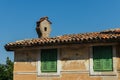 Part of an old Croatian house with a chimney on the roof against the blue sky on a sunny day Royalty Free Stock Photo