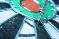 part of an old dart board with a close-up of the dart hit near the center Royalty Free Stock Photo