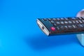 Part of old dirty tv remote console isolated on blue background Royalty Free Stock Photo