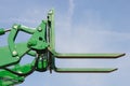 Part of old forklift loader or stacker on blue sky background. Modern technology Royalty Free Stock Photo