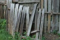 Part of an old gray wooden fence with broken boards Royalty Free Stock Photo