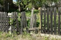 Part of an old gray wooden fence with broken boards Royalty Free Stock Photo