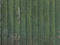 Part of old green painted barn door with vertical planks Royalty Free Stock Photo