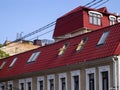 Part of an old house with a new modern red tiled roof Royalty Free Stock Photo