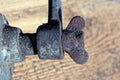 Part of an old iron grinder with a brown rusty screw Royalty Free Stock Photo