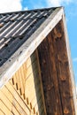 Part of old and rural brown house facade with roof