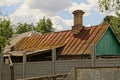 Part of an old rural house with a brown rusty iron roof Royalty Free Stock Photo