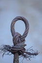 part of an old rusty brown steel cable with a knot and a loop Royalty Free Stock Photo
