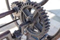 A part of an old well mechanism machine with sprocket wheels made of wrought iron close up detail Royalty Free Stock Photo