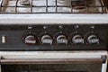 Part of one black whiteold dirty metal gas stove in the room Royalty Free Stock Photo