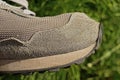 Part one gray sports sneaker made of suede and fabric with a black sole on the street Royalty Free Stock Photo