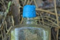 part of one old glass gray bottle with a cracked blue plastic stopper from perfume Royalty Free Stock Photo