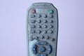 Part on one old gray dirty plastic television remote control