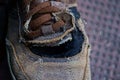 Part of one old torn brown leather boot