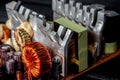 Part of pc power supply with radiator and electronic board with integrated stabilizers and filter capacitor with coils. Royalty Free Stock Photo