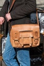 Part photo of a man with a yellow leather briefcase with antique and retro look. Outdoors photo Royalty Free Stock Photo