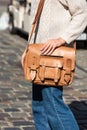 Part photo of a woman with a yellow leather briefcase with antique and retro look. Outdoors photo Royalty Free Stock Photo