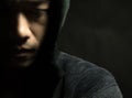 Part of the picture. Young man of Asian wear black sweater with hood.