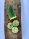 Part of a piece of cucumber that is arranged in a certain pattern with the benefits of cucumber for health. in portrait position