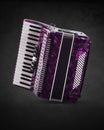Part pink accordion on grey background. Write text
