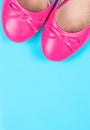 Part of pink shoes on blue