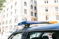 Part of the police car is a siren on the background of the buildings. Conceptual photo of public order protection