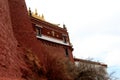 The part of the Potala Palace, with the people republic of China flag inside as well as many windows, curtain, Brick wall, Potala Royalty Free Stock Photo