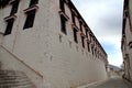 The part of the Potala Palace, with the people republic of China flag inside as well as many windows, curtain, Brick wall, Potala Royalty Free Stock Photo