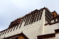 The part of the Potala Palace, with the people republic of China flag inside as well as many windows, curtain, Brick wall, Potala Royalty Free Stock Photo