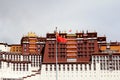 The part of the Potala Palace, with the people republic of China flag inside as well as many windows, curtain, Brick wall, Potala