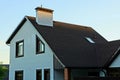 Part of a private house with windows and a roof under a brown tile against Royalty Free Stock Photo