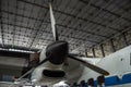 A part of a propeller aircraft standing in the hangar