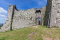 Part of Radicofani fortress remains with a doorway ornament and blue sky background. Tuscany, Italy