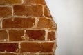 Part of the red brick wall of an old house with a figured pattern of white putty. Background, contrasting texture. Royalty Free Stock Photo