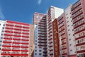 Part of residential building with many red loggias at summe