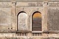 Part of residential building with old windows wooden shutters and window is walled up, closeup / Building facade elements. Royalty Free Stock Photo