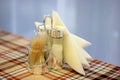 Part of restaurant table setting salt, pepper, toothpicks and paper napkins in wooden box on table