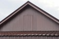 Part of a rural house with a brown wooden attic with a closed door Royalty Free Stock Photo