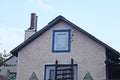 part of a rural house from a gray brown concrete attic and a small white closed door Royalty Free Stock Photo