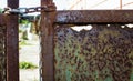 Part of rusty gate with chain and lock