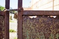 Part of rusty gate with chain and lock