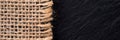 Part of sackcloth with black background. Woven burlap panorama