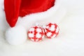 Part of Santa Claus hat with pom-pom and two red and white Christmas balls