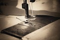 Part of sewing machine and fabric. horizontal, sepia, monochrom Royalty Free Stock Photo