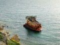 Part of the shipwrecked ship in water near the shore