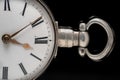 Part of a silver antique pocket watch dial with an eyelet for chain on a black isolated background. Retro clock with Royalty Free Stock Photo