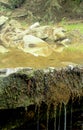 Part of a small waterfall and a view with stones in the background